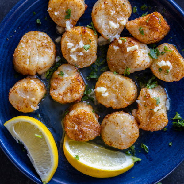 Air Fryer Scallops on a plate with lemon.