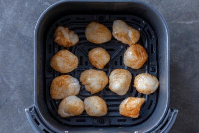 Air fryer basket with Scallops.