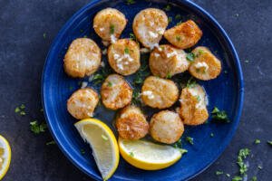 Plated Air Fryer Scallops with lemon.