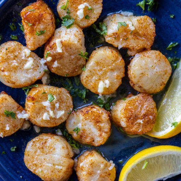 A plate with Air Fryer Scallops and lemons.