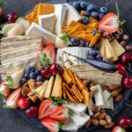 Cheese Board with berries and crackers and nuts.