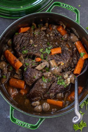 A dutch oven with beef and veggies.