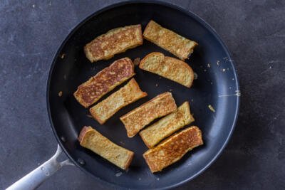 Toast sticks in a frying pan.