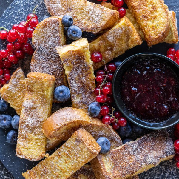 French Toast Sticks on a tray with berries.