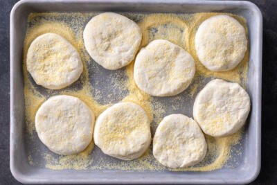 Cut out English Muffins dough on a baking sheet.