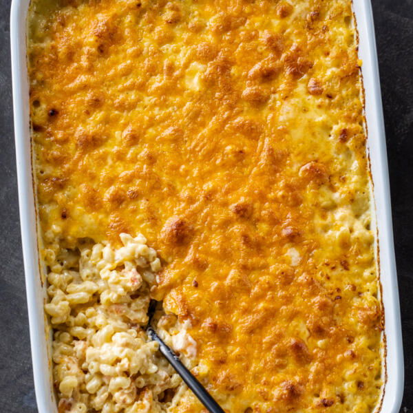 Lobster Mac and Cheese in a pan with a spoon.