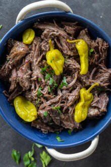 Pot Roast in a bowl with herbs.