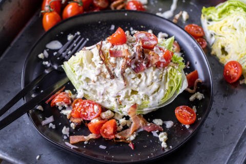 Wedge Salad with toppings on a plate.