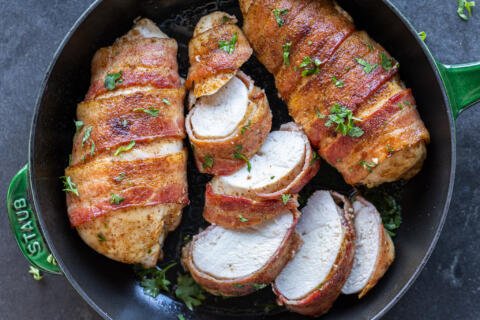 Sliced Bacon Wrapped Chicken Breasts in a serving pan.
