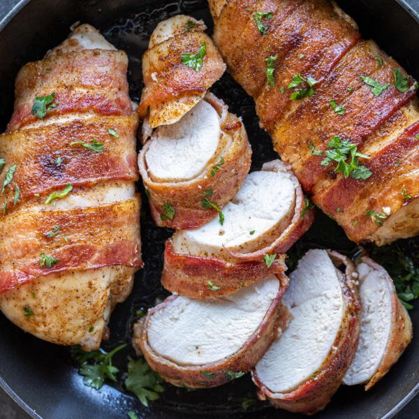 Sliced Bacon Wrapped Chicken Breasts in a serving pan.