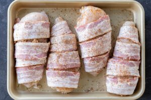 Seasoned bacon wrapped chicken breast.