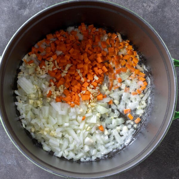 Pot with carrots, onions and garlic.