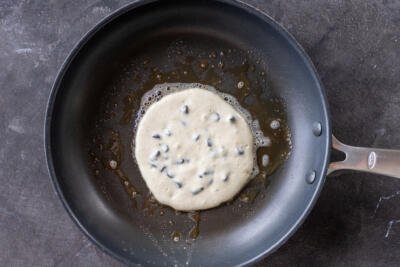 Chocolate Chip Pancakes on a pan with melted butter.