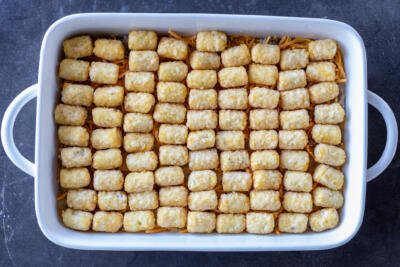 Tater Tots added to the pan.