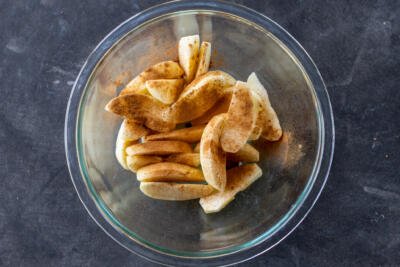 Apples with cinnamon in a bowl.