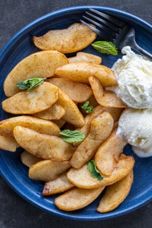 Air Fryer Apples on a plate with ice cream.