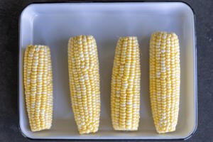 Peeled corn on a plate.