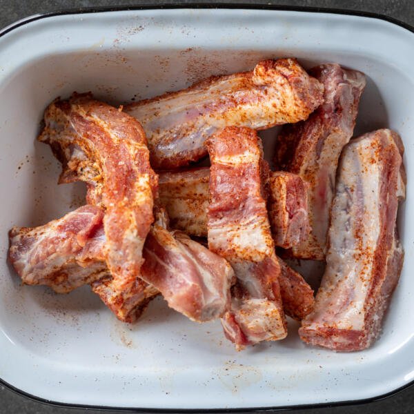 Seasoned pork ribs in a bowl.
