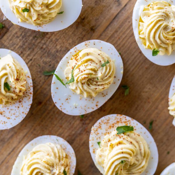 Deviled Eggs with herbs and toppings.