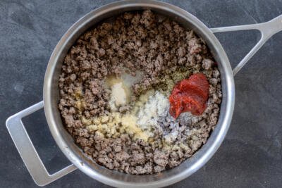 Cooked ground beef with seasoning and tomato paste.