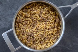 Pan with cooked pasta and beef in a pan.