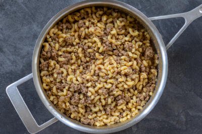 Pan with cooked pasta and beef in a pan.