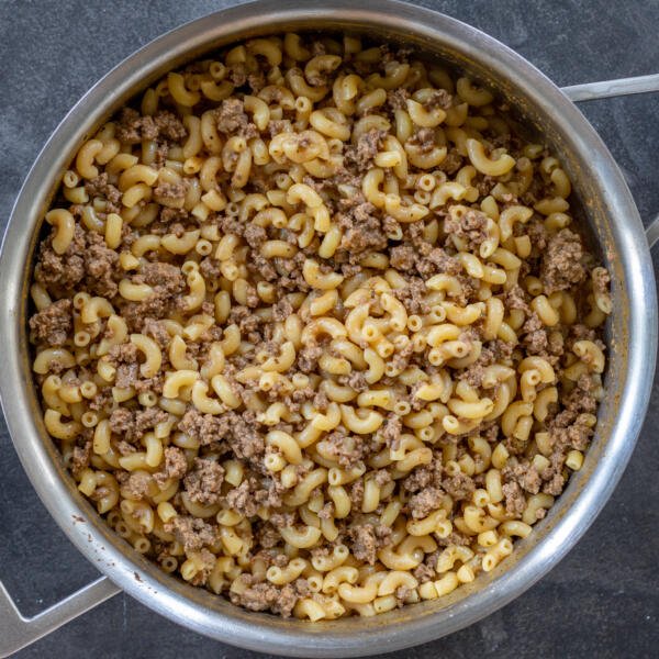 Pan with cooked pasta and beef in a pan.
