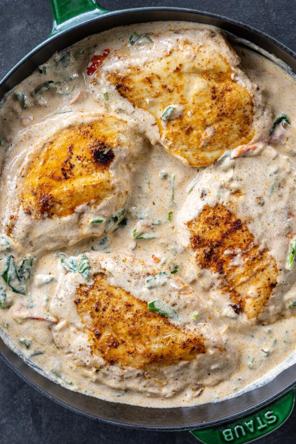 Chicken in a creamy sauce in a pan.