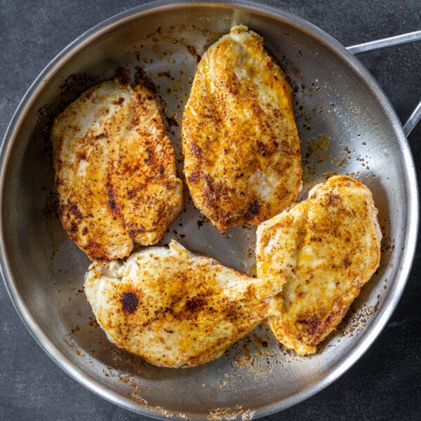 Browned chicken in a pan.