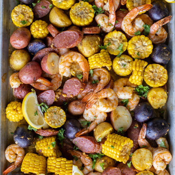 Baked shrimp boil on a baking sheet.