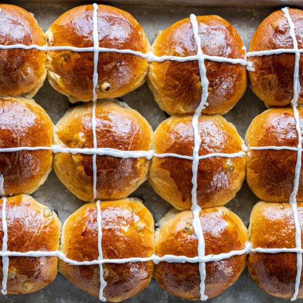 Soft Hot Cross Buns on a baking sheet.