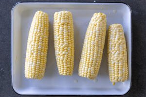 Buttered corn on a plate.