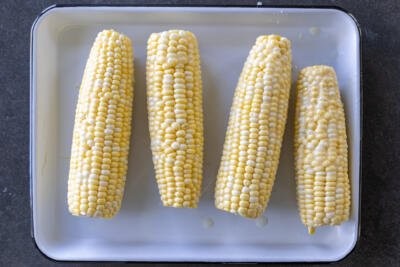 Buttered corn on a plate.