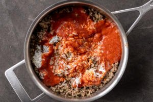 Sauce and rice added to the sauteed pan.