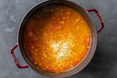 Cheese added to the pot of Chicken Enchilada Soup.