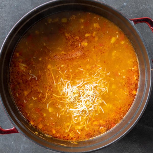 Cheese added to the pot of Chicken Enchilada Soup.