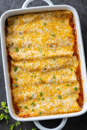 Baked Ground Beef Enchiladas in a pan.