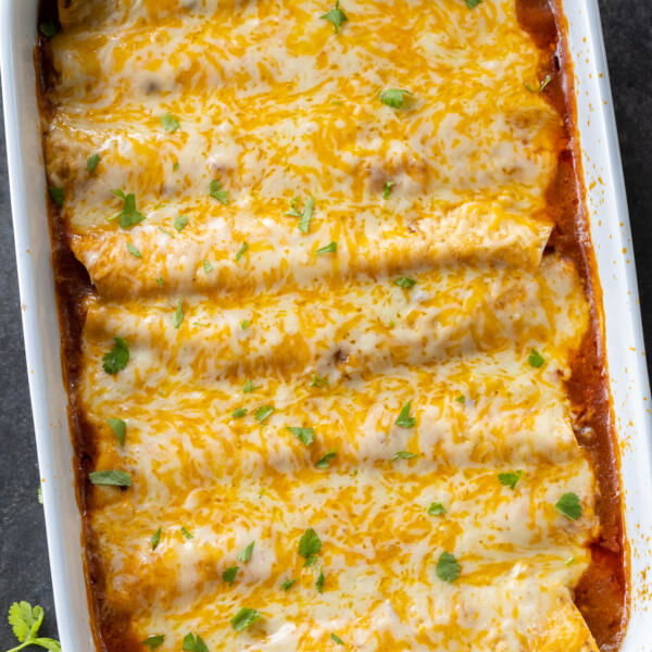 Baked Ground Beef Enchiladas in a pan.