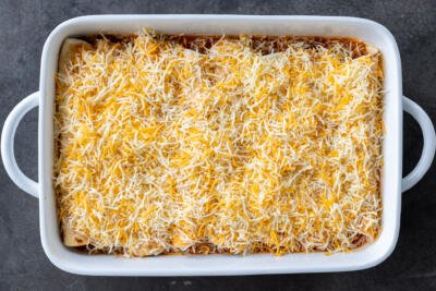 Ground Beef Enchiladas topped with cheese.