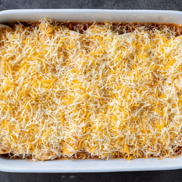 Ground Beef Enchiladas topped with cheese.