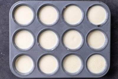 Eggs mixture in a muffin pan.