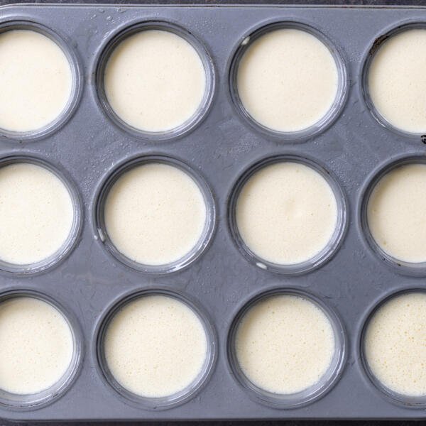 Eggs mixture in a muffin pan.