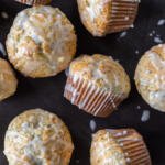 Baked Lemon Poppy Seed Muffins with glaze and lemon slices.