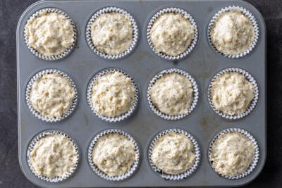 Muffin batter added to the muffin pan.
