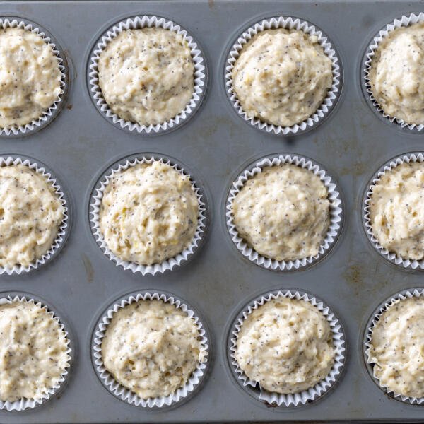 Muffin batter added to the muffin pan.