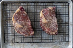 Basked steak on a wire baking sheet.