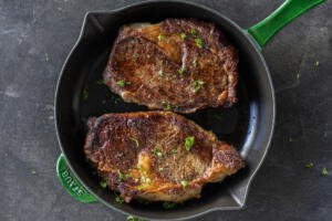 Reverse Sear Steak on a pan with herbs.