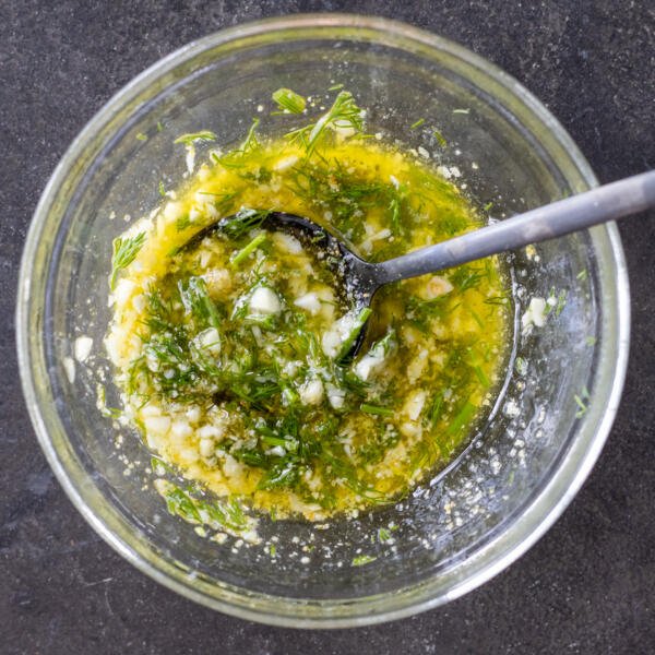 Butter, her with seasoning mixture in a bowl.