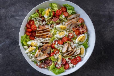 Cobb salad ingredients in a bowl.