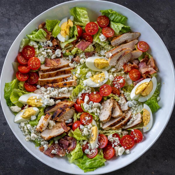 Cobb salad ingredients in a bowl.